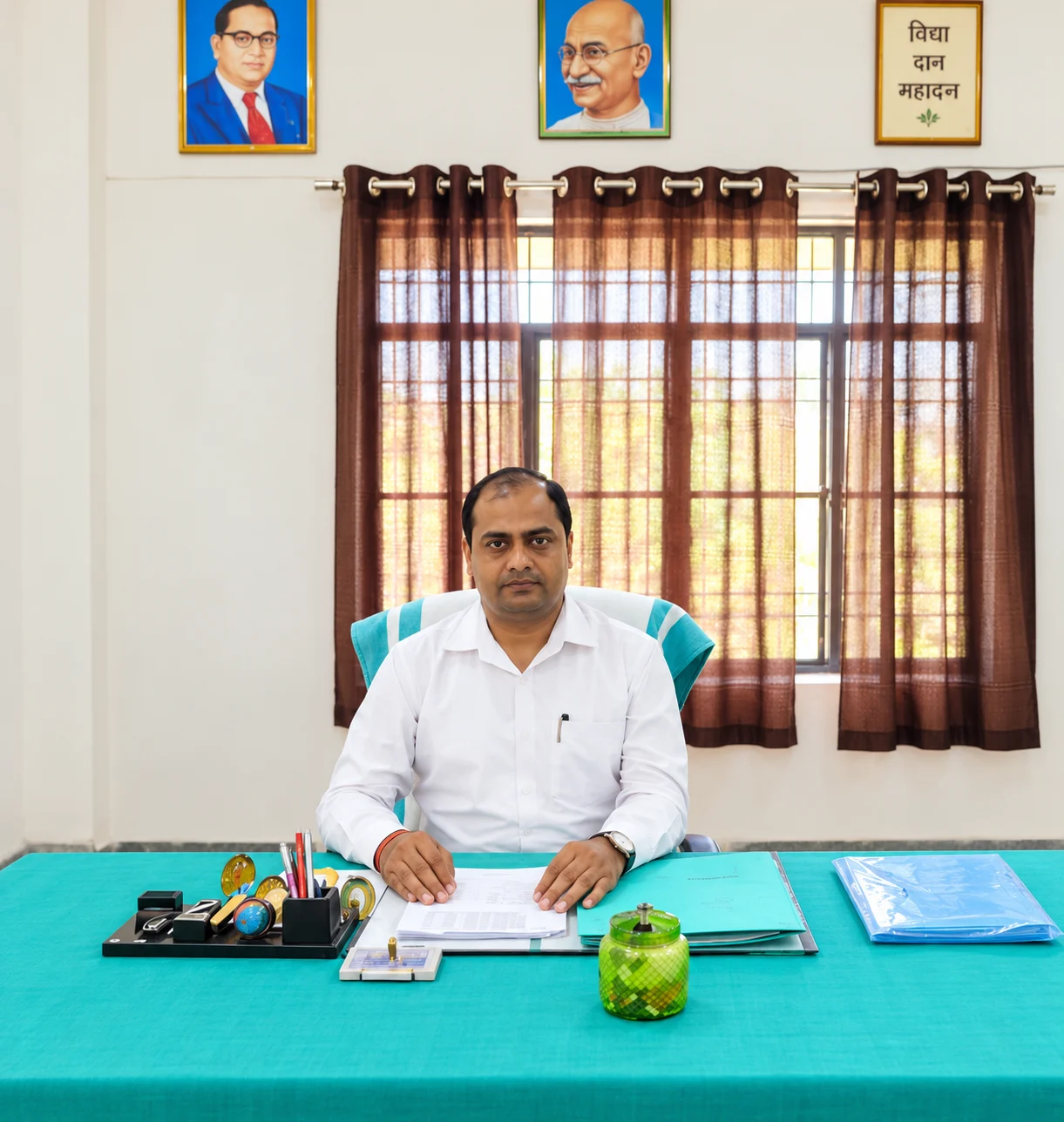 Mr. Dharmveer Singh Verma, Principal, seated at his desk